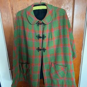 Dramatic wool cape in a green/purple/red plaid, black lining, frog closures